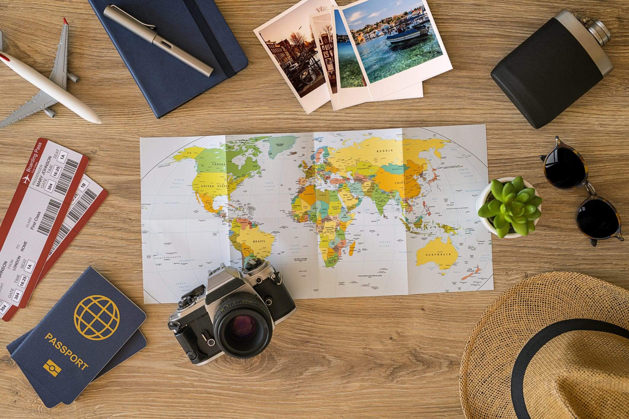 Travel essentials with world map on table.