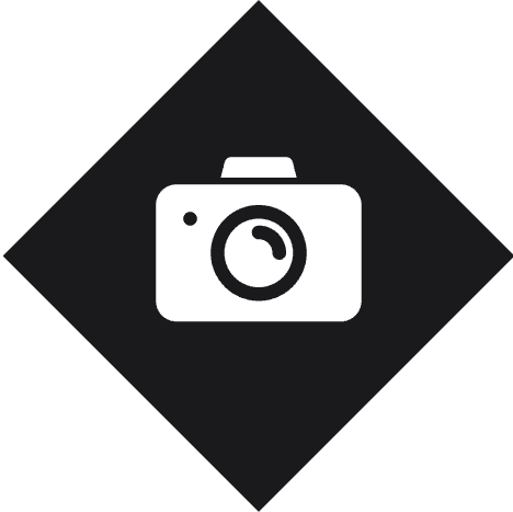 Camera icon on black diamond background.