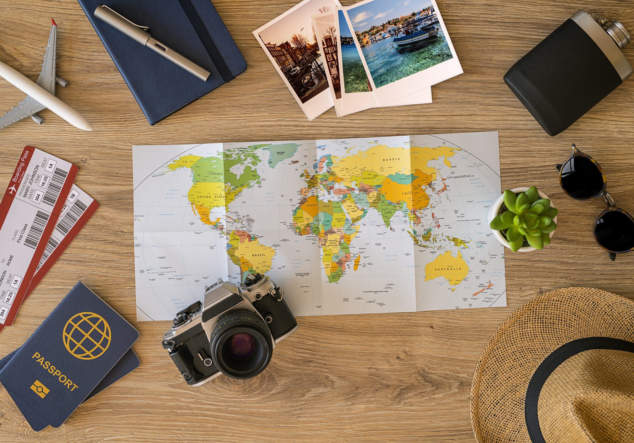Travel essentials with world map on table.